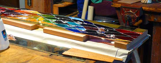The panel is raised on blocks of wood to create space for the crystals