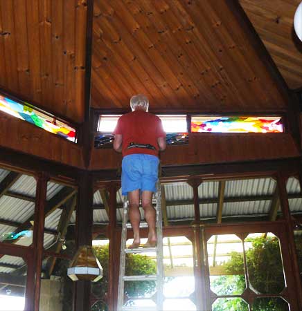 Carrying the last panel up the ladder 